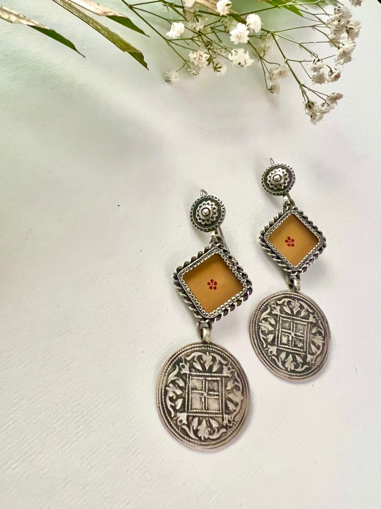 "Dhriti": Exotic and Exquisite dull orange earrings with striking versatile silver crafted hangings