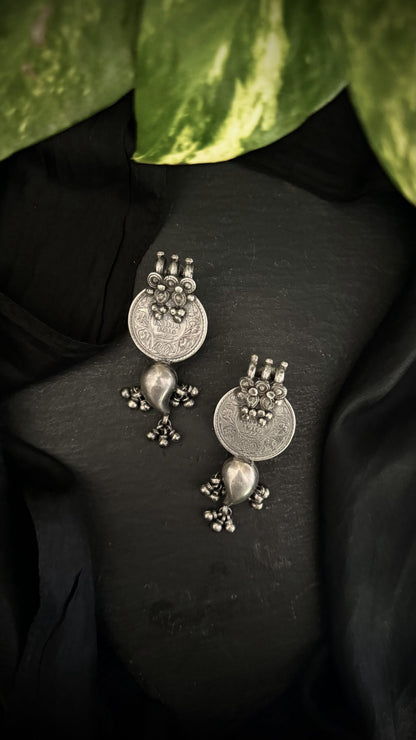 Cascading silver tales, these vintage earrings are an ode to the timeless beauty of a bygone era.