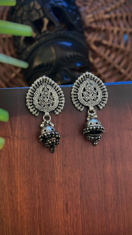 Whispers of Heritage: Adorn with Silver Jhumkas.